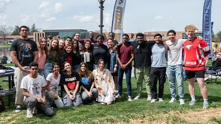 Group of international students smiling together outside.